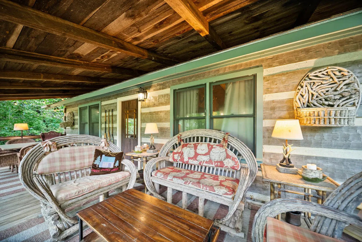 An inviting outdoor gathering space featuring woven chairs, a wooden table, and warm lighting. Sunset views and the comfortable set-up encourage group relaxation, birdwatching, and socializing after a day of exploration. The mood is peaceful and welcoming, ideal for families and groups to unwind together.